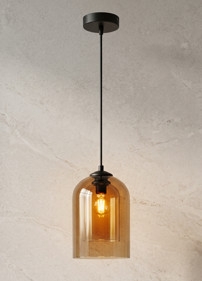 A single pendant light with a black metal canopy and cord, featuring a warm amber-tinted glass shade that glows with the illuminated bulb inside, set against a textured light beige wall.