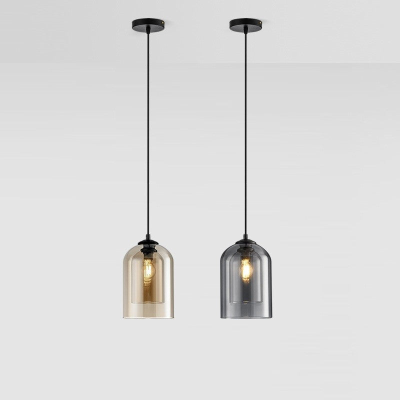 Two pendant lights with glass shades on a white background