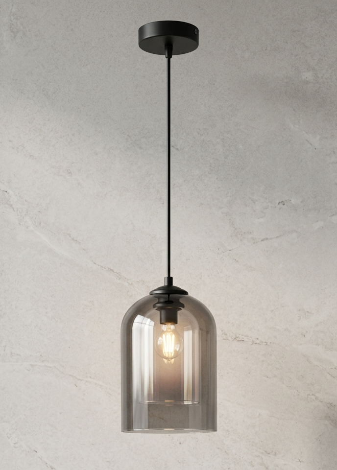 A modern pendant light with a black ceiling canopy and cord, featuring a smoky translucent glass bell shade that reveals a warm glowing Edison bulb, set against a textured light gray wall.
