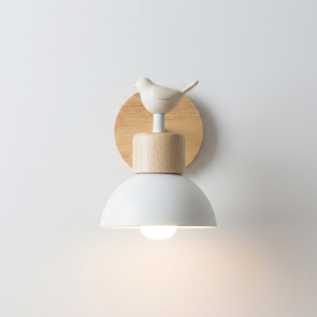 A modern wall-mounted bird-shaped light fixture with a white dome shade, light wood accents, and a small white bird on a circular wood backplate, shown against a plain light gray wall.