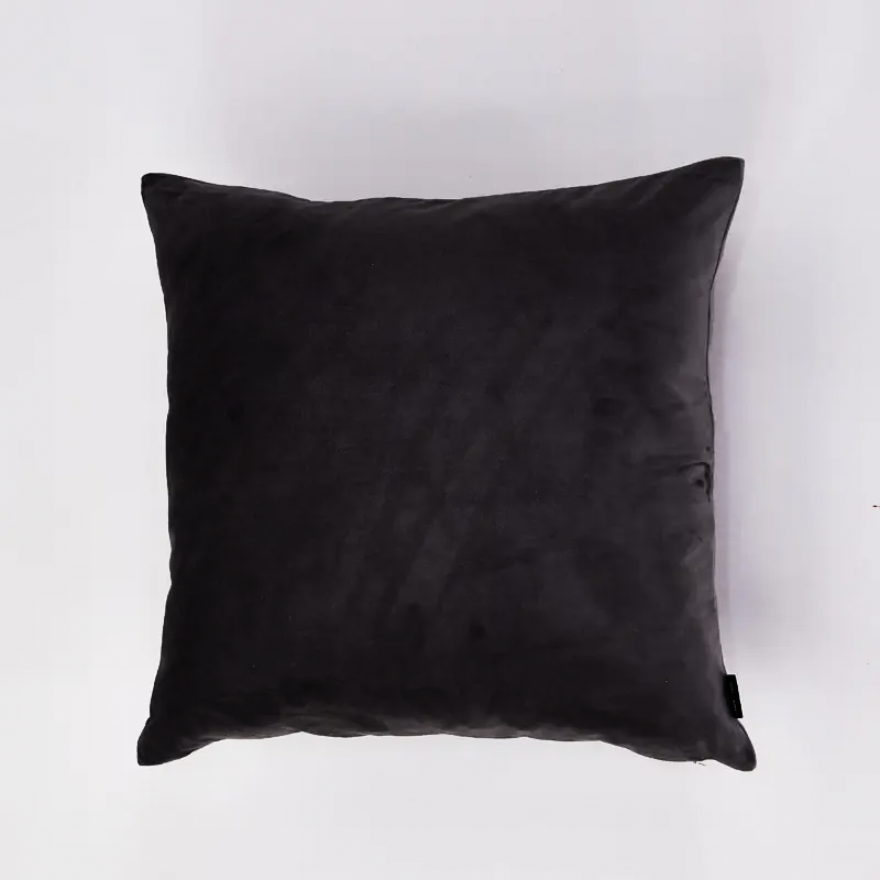 A square black throw pillow with a soft, slightly textured fabric, photographed from a top-down angle against a clean white background.