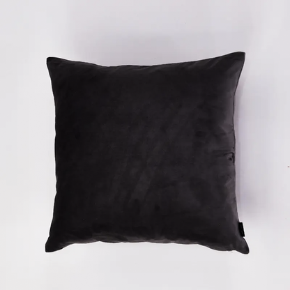 A square black throw pillow with a soft, slightly textured fabric, photographed from a top-down angle against a clean white background.