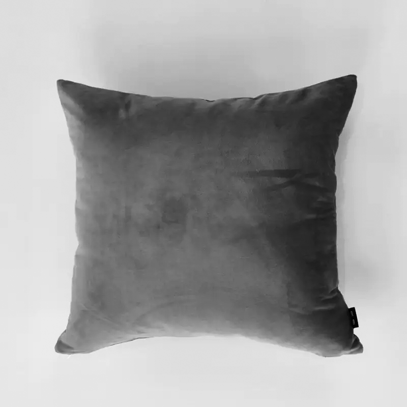 Gray velvet pillow on a light gray background