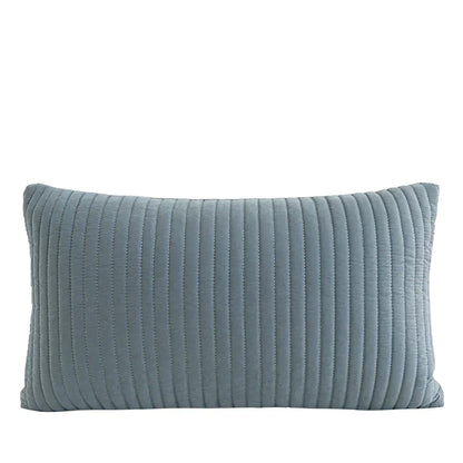 A rectangular lumbar pillow in a dusty blue-gray color with vertical channel tufting, shown against a plain white background.
