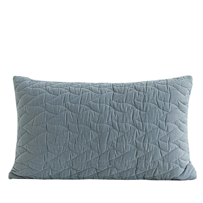 Quilted blue pillow on a white background